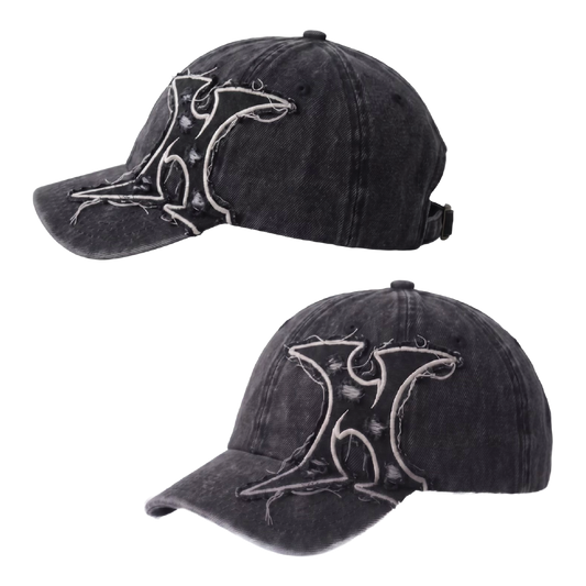 Two views of a washed black baseball cap with a distressed white graphic logo on the front, shown against a plain white background.